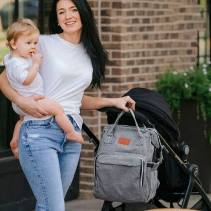 Sac a langer multifonction elegant bebe avec doigt dans la bouche